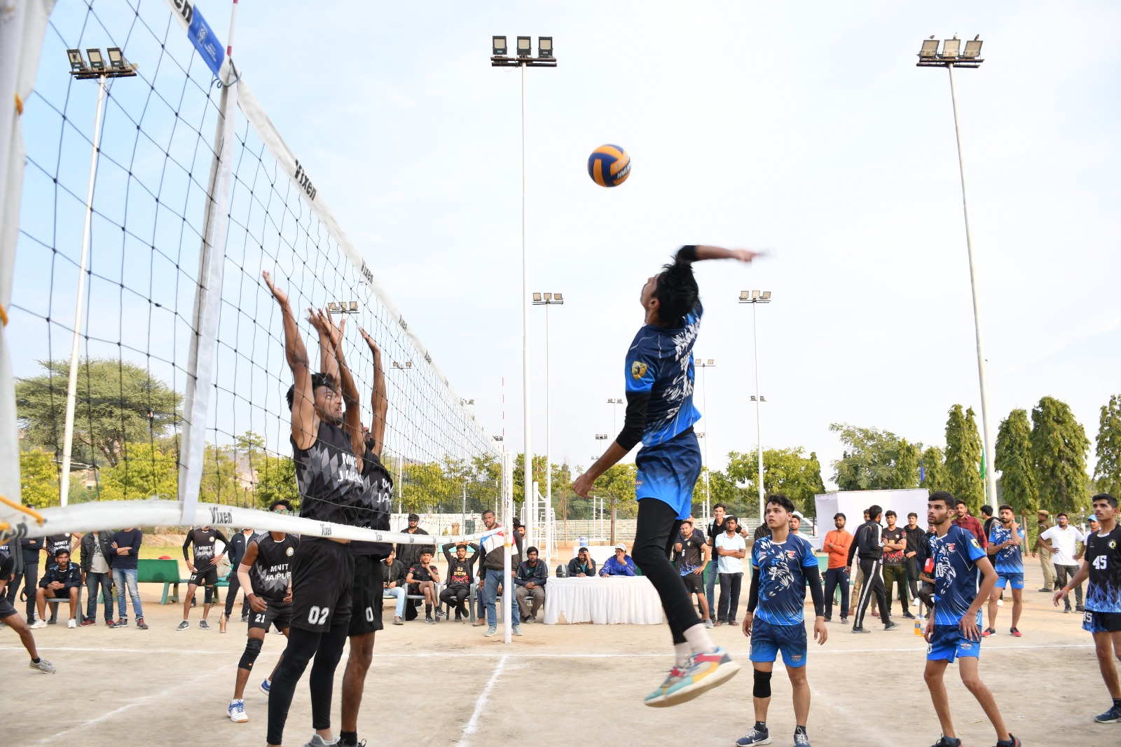 Players leaping for a powerful volleyball spike
